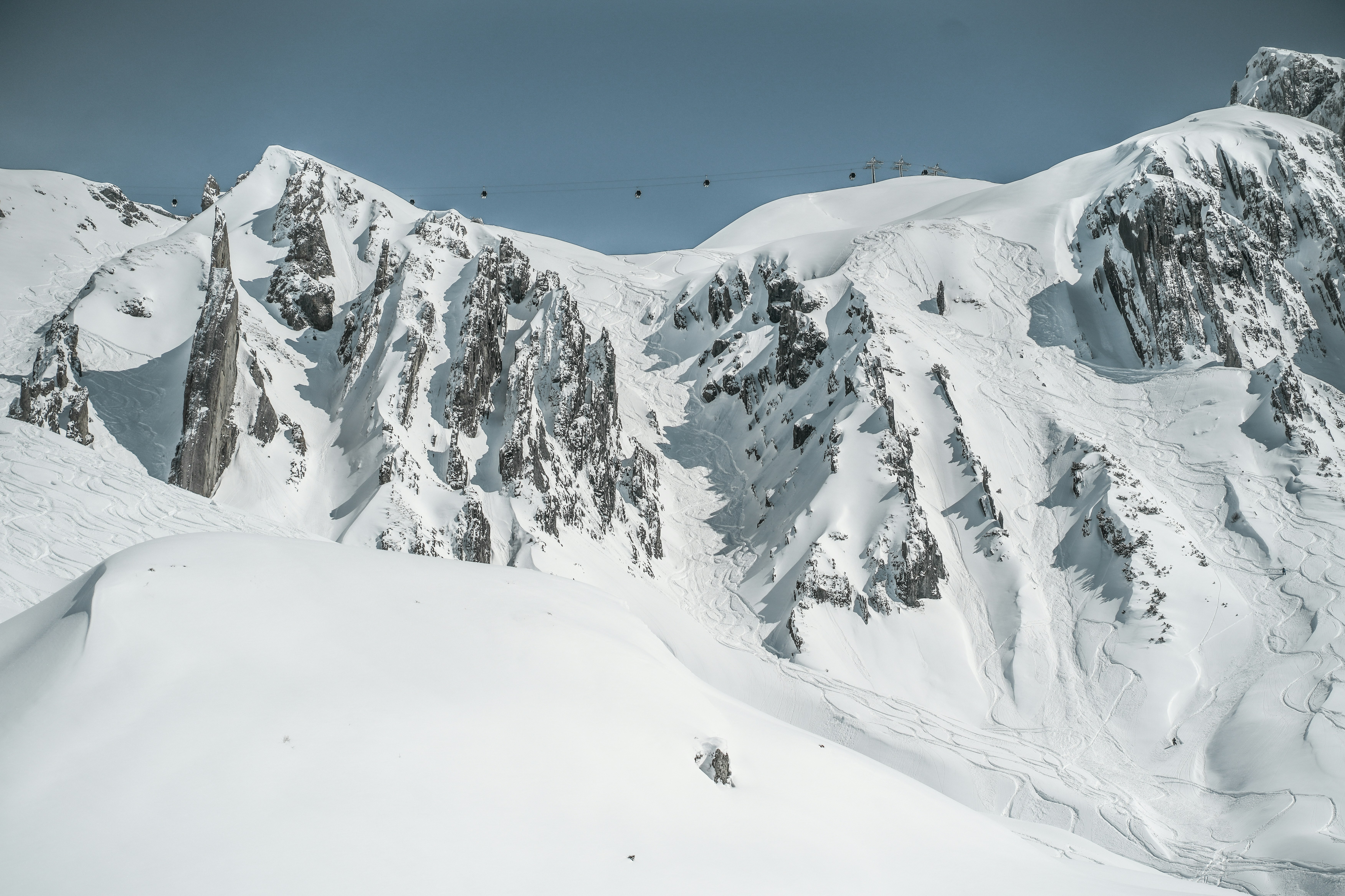 Snow-covered mountain landscape with ski tracks